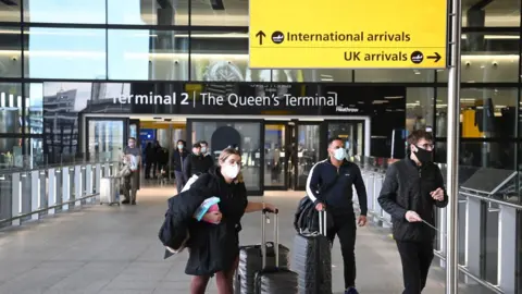 EPA Passengers arrive at Heathrow Airport in January