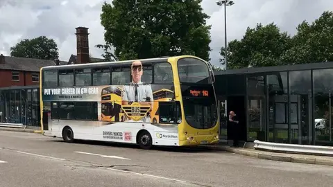Geograph/Dixon Go North West in the yellow "Bee Network" livery, waits at Bury Interchange on the 163 route to Manchester via Darnhill and Middleton.