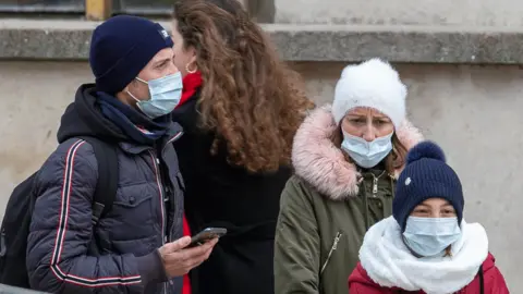 Getty Images Family in face masks