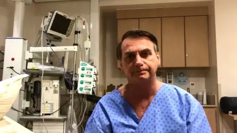 AFP Brazil's President Jair Bolsonaro speaking before undergoing surgery to remove a colostomy bag at the Albert Einstein Hospital in Sao Paulo, Brazil, on 27 January 2019
