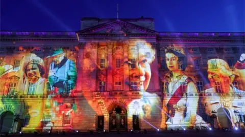 Reuters Buckingham palace with Queen's faces on