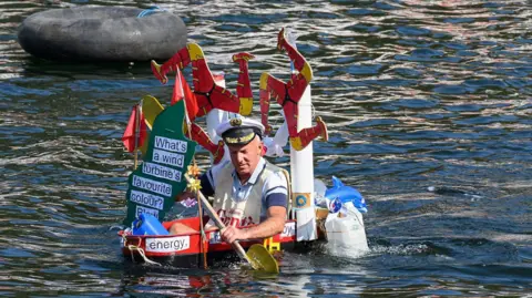MANX SCENES A competitor in a bath decorated to look like wind turbines with the three legs of Man as blades.