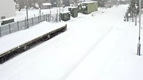 ScotRail A deep blanket of snow covers a railway station platform