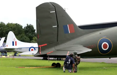 AFP Visitors look at a vintage war plane in an outdoor museum