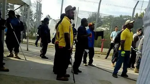 Papua New Guinean police officers enter the Manus Island immigration detention centre in Papua New Guinea November 23, 2017