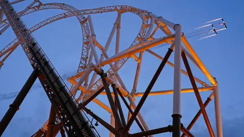 Planes fly behind the Hyperia rollercoaster at Thorpe Park on 23 May
