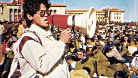 Yan Xiong pictured with loudspeaker at Tiananmen Square