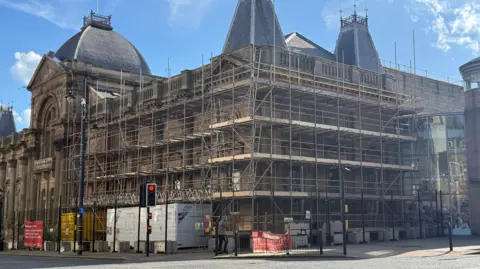 BBC The outside of the museum with extensive scaffolding.