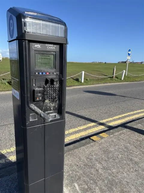 A parking meter in front of the West Links at North Berwick