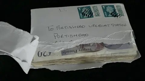 RNLI Portishead Ripped open envelope full of cash