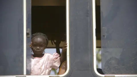 Getty Images A girl on a bus on the Guinea-Burkina Faso border - archive shot