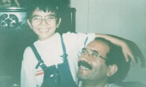 Supplied Sohrab sits with his father Mohammad Mokhtari