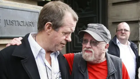 PA Media Michael Hamilton (left), father of Vicky Hamilton and father of Dinah McNicol outside the Edinburgh High Court