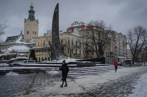 Getty Images Citizens carry on with their daily lives in Lviv, which is one of the safest cities since the beginning of the war between Russia and Ukraine despite the occasional sirens and possible attacks in Ukraine on February 17, 2023.