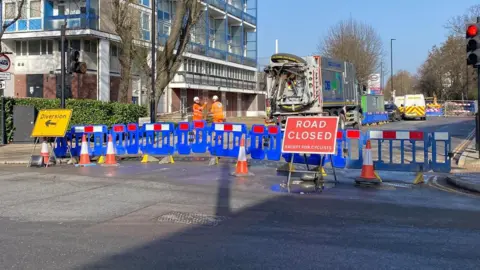 A road closed off with a barrier 