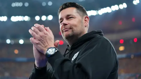 Pierre Sage clapping his hands