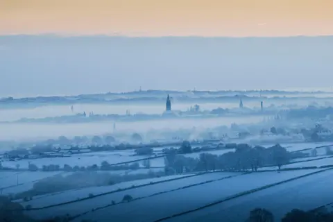 Alamy Live News Little Horton, Bradford, silhouetted by the early morning sun, on 15 January