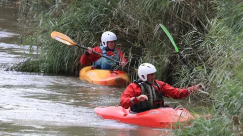 PA Media Search teams in canoes combing the dense vegetation on the riverbank