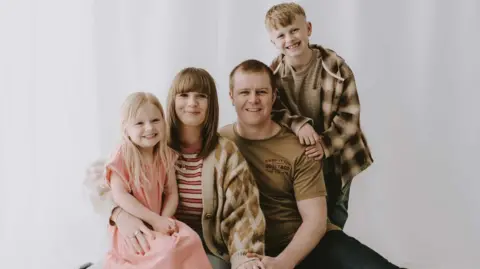 HELAYNA INGHAM A family photograph of the Ingham family together smailing.
