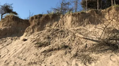 HM Coastguard The collapsed sand dune on Newborough Beach, Anglesey