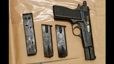 PSNI Cash, handguns, grenades, ammunition and plastic explosives were uncovered