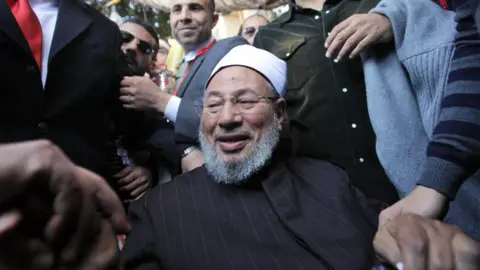 EPA Muslim cleric Yusuf al-Qaradawi is welcomed by a crowd in Cairo's Tahrir Square on 18 February 2011