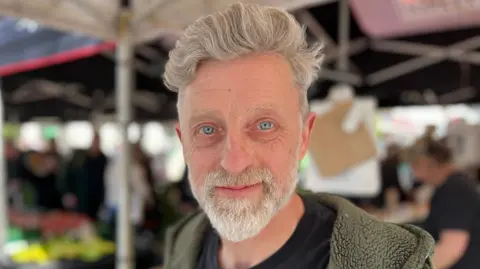 BBC/Lucinda Adam A man with a white beard, white hair and blue eyes.