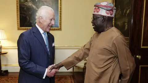 King Charles shaking hands with President Tinubu of Nigeria