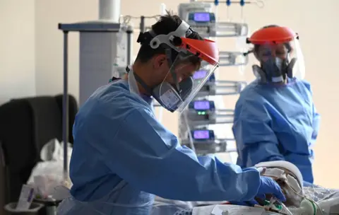 Getty Images Two surgeons in PPE