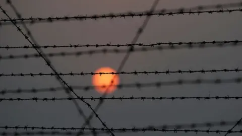 Getty Images A barbed wire fence is pictured at the India-Pakistan border in R.S Pora, southwest of Jammu, on October 3, 2016.