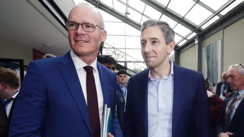 PA Media Simon Coveney and Simon Harris