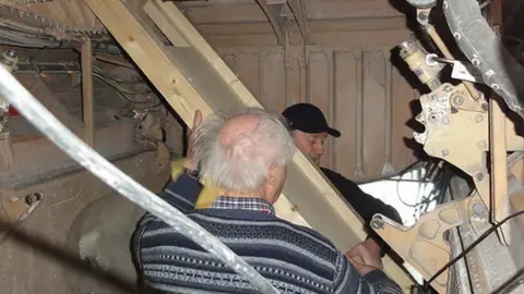 Aerospace Bristol Members of the team are trying to get part of the aircraft's electrical system working in order to select the nose up and down