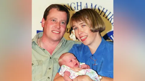 PA Media Roger and Karen Humphries reunited with baby Abbie in July 1994