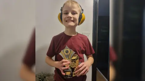 Supplied Abbie Thompson's son holding the trophy he got from the Kimberley Swimming Club for dedication.