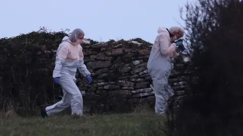 Andrew Matthews/PA Forensic officers