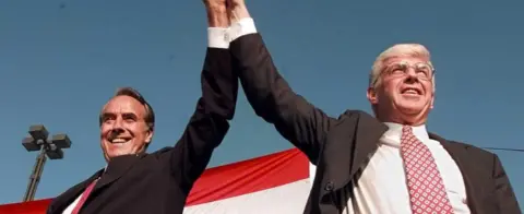 AFP US Republican presidential candidate Bob Dole (L) and vice presidential candidate Jack Kemp (R) arrive for a welcoming rally in San Diego, California, 14 October 1996