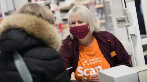 Sainsbury's Sainsbury's worker on a till