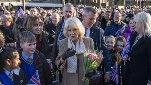 PA Media The Queen Consort meeting members of the public during a visit to Bolton Town Hal