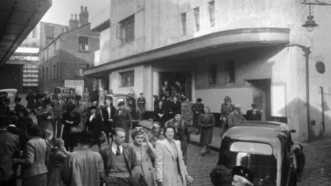 Getty Images Crowds coming out of Oldham Coliseum theatre in 1946