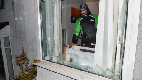 Robert Melen Mr Romain at the window with glass over the baby cot