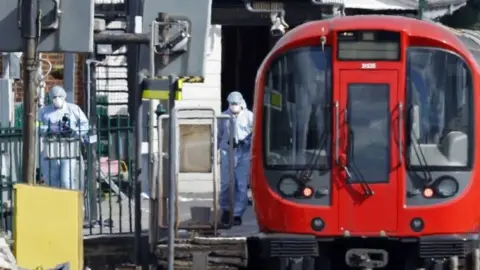 AFP Forensic officers at a London Underground train