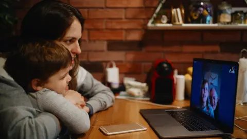 Getty Images A mum and child Skyping grandparents