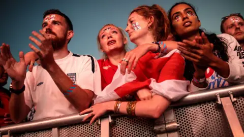 Getty Images Sad England fans watch the game