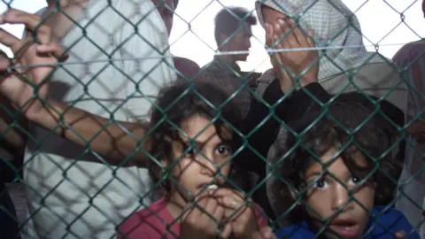 Getty Images Asylum seekers arrive at Nauru off the Australian Navy troop carrier HMAS Manoora, 19 September 2001