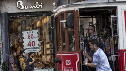 EPA People shopping while a historical tram passes by in Istiklal Street in Istanbul