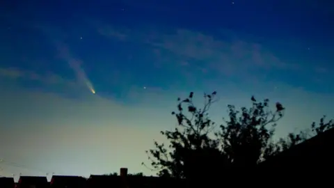 Bill/BBC Weather Watchers Comet A3 above roof tops and trees in Musselburgh, East Lothian.