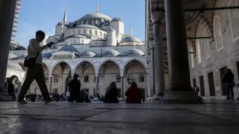 Pope Leo XIV to visit Turkey and Lebanon in first foreign trip of his papacy EPA People rest in the shade in front of Istanbul's Blue Mosque.
