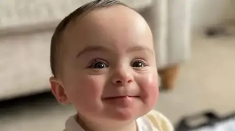 Close up of the smiling face of the late nine-month-old Genevieve Meehan