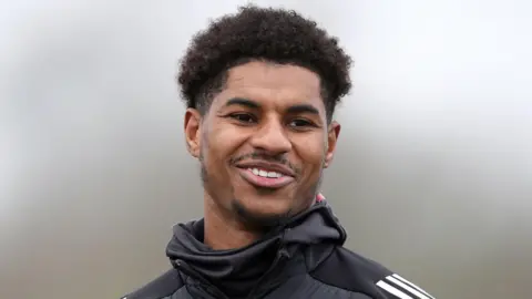 PA Media Marcus Rashford, smiling, during a training session for Manchester United at the Trafford Training Centre, Carrington. 