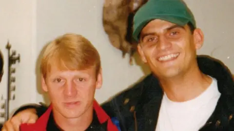 Matt Appleby An old photograph of Matt Appleby in his 20s, wearing a green cap with his arm around then Forest player Stuart Pearce. 